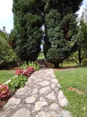 a stone path with a bench in a park at Holiday home 