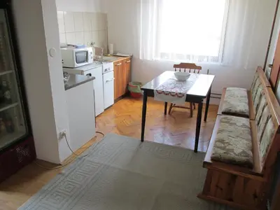 a small kitchen with a table and a microwave at Country House Roman in Doboj