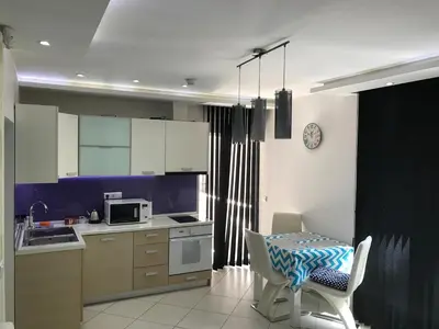 a kitchen with a table and a dining room at Apartment Ajla in Tuzla