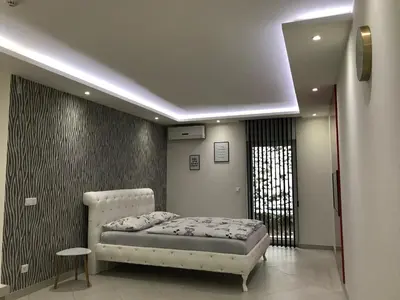 a bedroom with a bed in a room with a window at Apartment Ajla in Tuzla