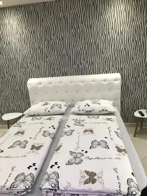 a bed with two pillows on it in a bedroom at Apartment Ajla in Tuzla