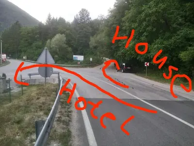 a street with red writing on the side of a road at Apartman Relax in Nature in Jajce