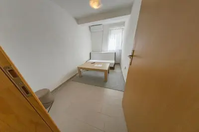 a small room with a bench and a table at Apartment Resaa in Bihać