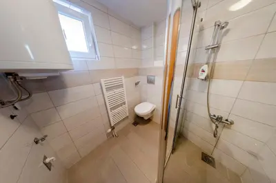 a bathroom with a shower and a toilet in it at Apartment Resaa in Bihać