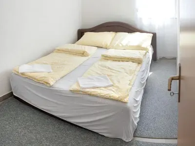 a bed in a room with two pillows on it at Apartment Resaa in Bihać