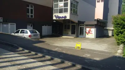 a car parked in a parking lot in front of a building at Apartment Sarah in Bihać