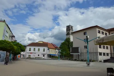 a city street with buildings and a clock tower at Apartment Sarah in Bihać