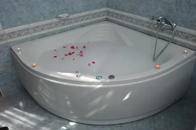a white bath tub with red confetti in it at Apartment Sarah in Bihać