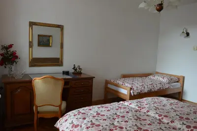 a bedroom with a bed and a dresser and a mirror at Apartment Sarah in Bihać