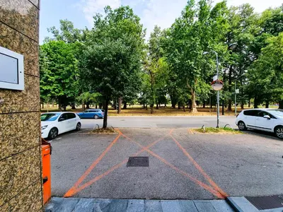 a parking lot with cars parked in a park at Apartments Alf - Om in Banja Luka