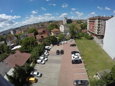 a bunch of cars parked in a parking lot at Apartments Alf - Om in Banja Luka