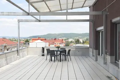 a patio with a table and chairs on a balcony at Apartments Alf - Om in Banja Luka