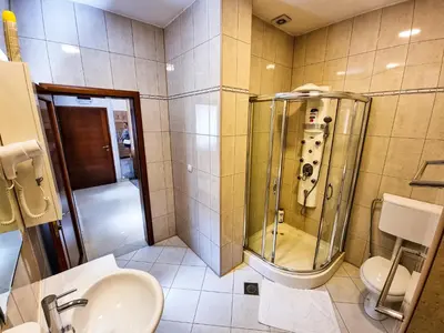 a bathroom with a shower and a sink and a toilet at Apartments Alf - Om in Banja Luka