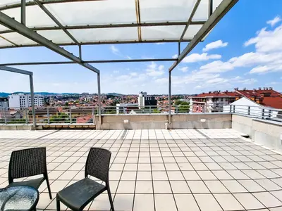 two chairs sitting on the roof of a building at Apartments Alf - Om in Banja Luka