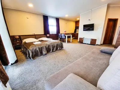 a hotel room with two beds and a couch at Apartments Alf - Om in Banja Luka