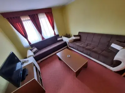 a living room with a couch and a tv at Motel Tiron in Kakanj