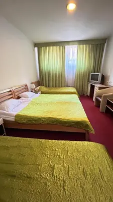 a hotel room with two beds and a television at Motel Tiron in Kakanj