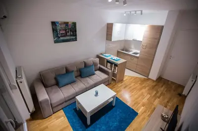 a small living room with a couch and a table at Jelena Apartment in Doboj