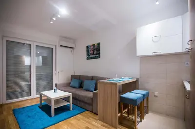 a living room with a couch and a table at Jelena Apartment in Doboj