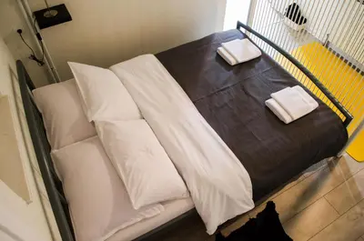 a white bed with white pillows on top of it at Apartment Fortuna in Visoko