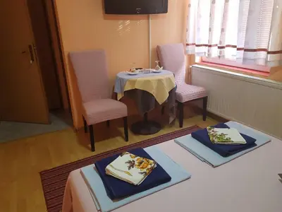 a room with a table and two chairs and a table and a table and chairs at Guesthouse 