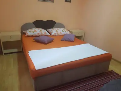 a bedroom with a large bed with pillows on it at Guesthouse 