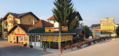a yellow building with a restaurant on a street at Guesthouse 