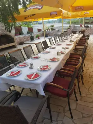 a long table with plates and napkins on it at Guesthouse 