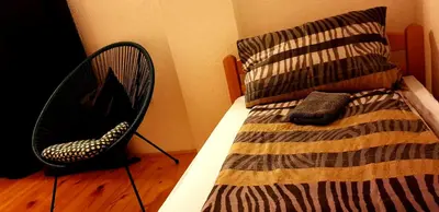 a bedroom with a bed with a pillow and a chair at Holidayhouse Visoko in Visoko