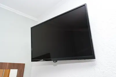 a flat screen tv hanging on a wall at Motel Plaza in Jajce