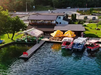 a group of boats parked at a dock on the water at Motel Plaza in Jajce