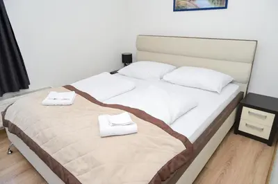 a bedroom with a bed with two towels on it at Motel Plaza in Jajce