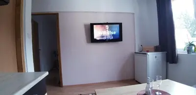 a living room with a television on the wall at Apartment Sajra in Kulen Vakuf