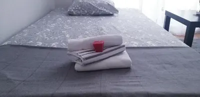 a pile of towels sitting on top of a bed at Apartment Sajra in Kulen Vakuf