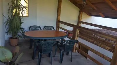 a table and chairs on the balcony of a house at Apartment Sajra in Kulen Vakuf