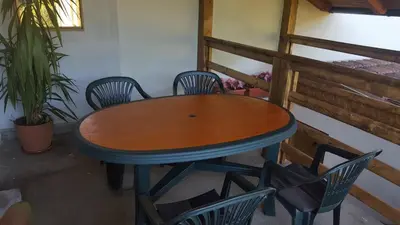 a wooden table and chairs in a room at Apartment Sajra in Kulen Vakuf