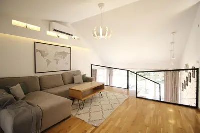 a living room with a couch and a table at La Paloma Blanca in Tuzla