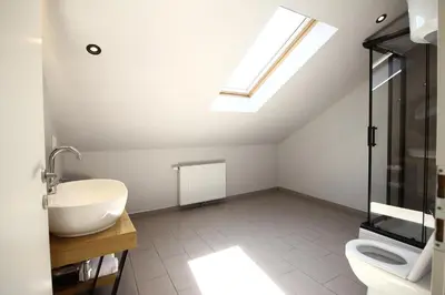 a bathroom with a sink and a skylight at La Paloma Blanca in Tuzla