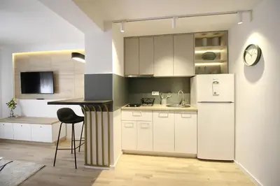 a kitchen with a white refrigerator and a counter at La Paloma Blanca in Tuzla