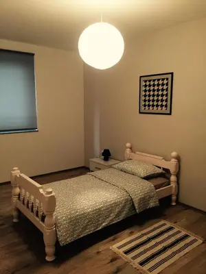 a bedroom with two beds and a large light fixture at Apartment Adi in Travnik