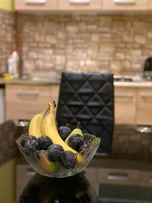 a bowl of fruit on a counter in a kitchen at Apartments & Rooms Fountain in Bihać