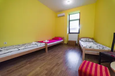 a room with two beds and a window at Apartments & Rooms Fountain in Bihać