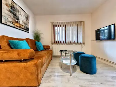 a living room with a couch and a glass table at Apartmani Abbazia in Banja Luka