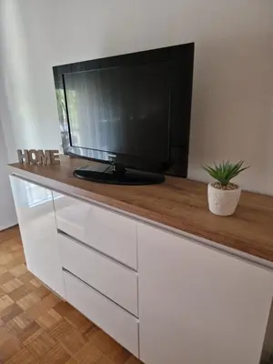 a tv sitting on top of a white dresser at Guesthouse Irac in Tuzla
