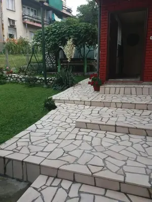 a brick walkway in front of a house at Guesthouse Irac in Tuzla