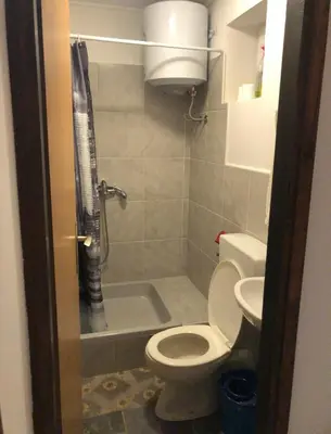 a bathroom with a toilet and a shower and a sink at Prenoćište Gany in Jajce
