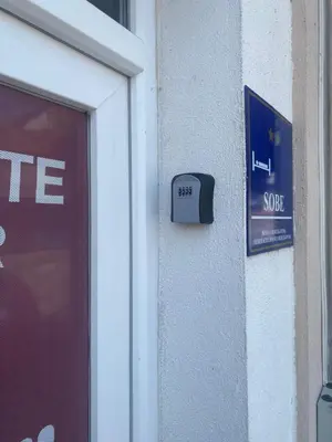 a sign on the side of a building next to a door at Prenoćište Gany in Jajce
