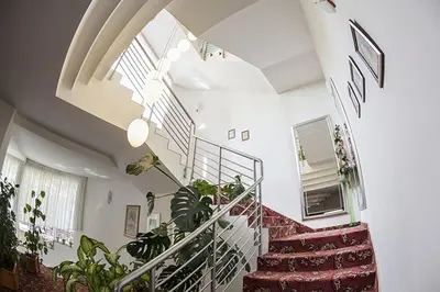 a white staircase with plants in a room at Hotel Senad od Bosne in Prokosovići