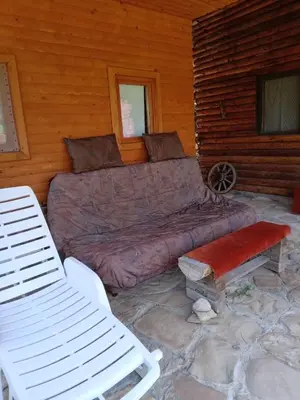 a large bed in the back of a log cabin at Piramida Mjeseca in Visoko