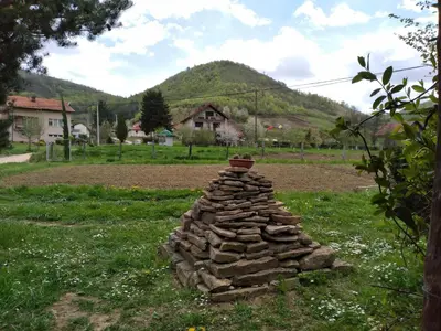 a stack of rocks in the middle of a field at Piramida Mjeseca in Visoko